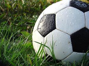 Soccer Ball In The Grass Covered By Rain
