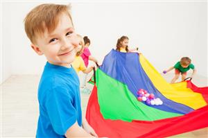 Smiling boy with parachute.